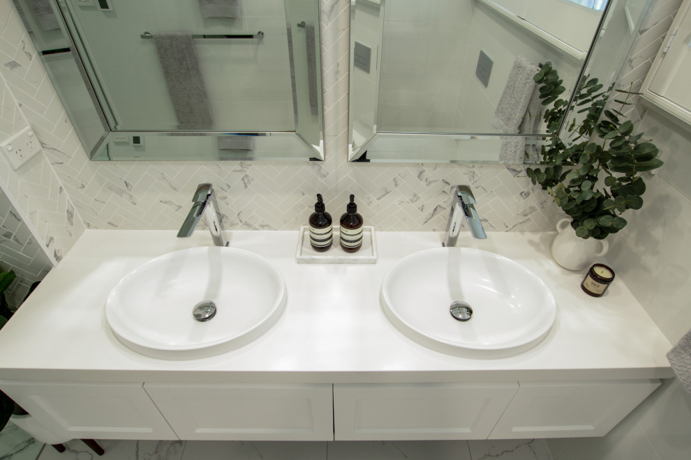Design ideas for a large contemporary 3/4 bathroom in Sydney with shaker cabinets, white cabinets, a one-piece toilet, a hinged shower door, white benchtops, a niche, a double vanity and a floating vanity.
