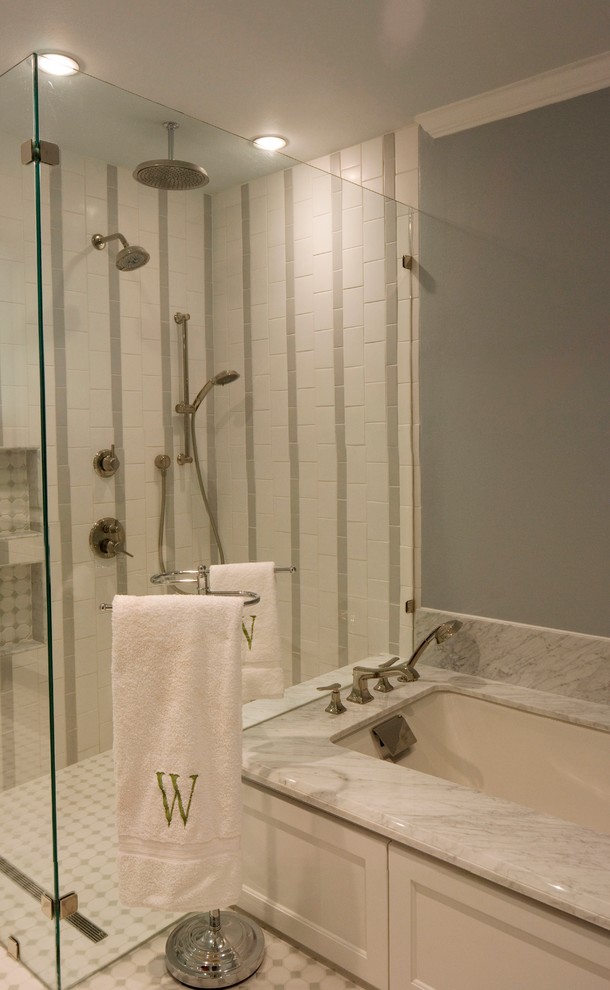 Inspiration for a mid-sized transitional master white tile and ceramic tile ceramic tile and white floor walk-in shower remodel in Houston with white cabinets, marble countertops, an undermount tub, gray walls, a hinged shower door and white countertops