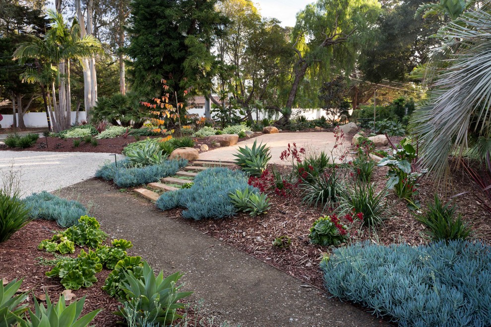 Photo of a mid-sized front yard partial sun driveway for winter in Santa Barbara with a garden path and gravel.