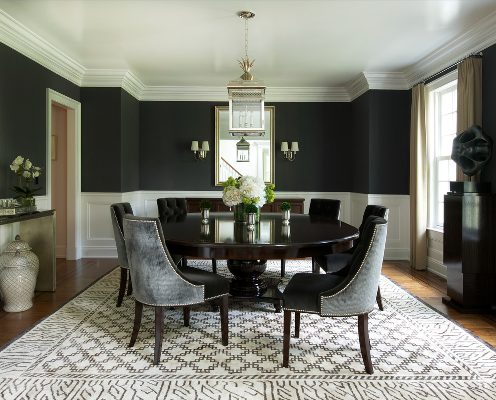 Photo of a large transitional separate dining room in New York with black walls, medium hardwood floors and no fireplace.
