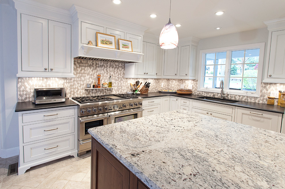 Photo of a mid-sized traditional l-shaped eat-in kitchen in Other with an undermount sink, beaded inset cabinets, white cabinets, granite benchtops, green splashback, stainless steel appliances and with island.