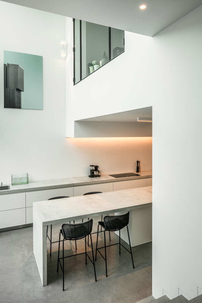 Photo of a modern kitchen in Angers with concrete benchtops.
