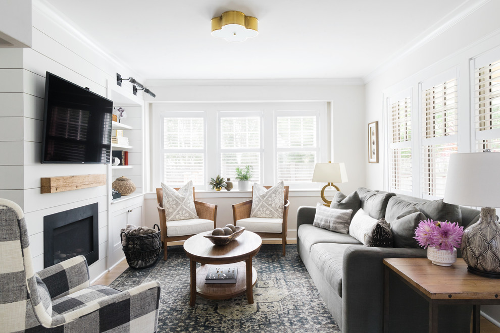 Inspiration for a small traditional open concept family room in Boston with white walls, medium hardwood floors, a standard fireplace, a wood fireplace surround and a wall-mounted tv.