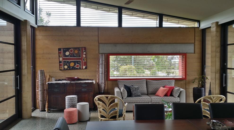 Mid-sized eclectic open concept family room in Other with concrete floors, beige walls and grey floor.