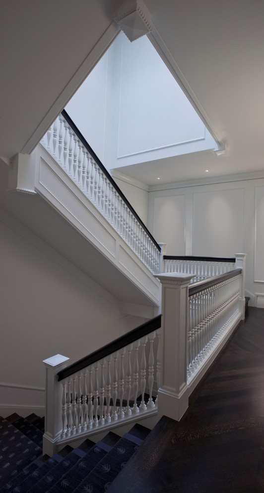 Large traditional wood staircase in Chicago with wood risers.