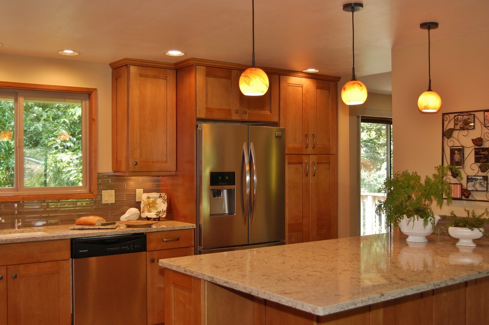 Example of a small transitional l-shaped open concept kitchen design in Portland with an undermount sink, shaker cabinets, medium tone wood cabinets, quartz countertops, brown backsplash, glass tile backsplash, stainless steel appliances and a peninsula
