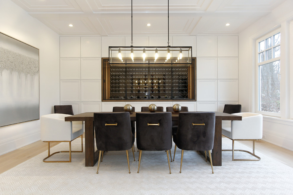 This is an example of a large contemporary separate dining room in New York with white walls, light hardwood floors, no fireplace and brown floor.
