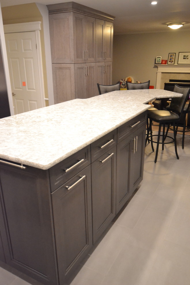 Inspiration for a mid-sized transitional u-shaped eat-in kitchen remodel in Ottawa with recessed-panel cabinets and an island