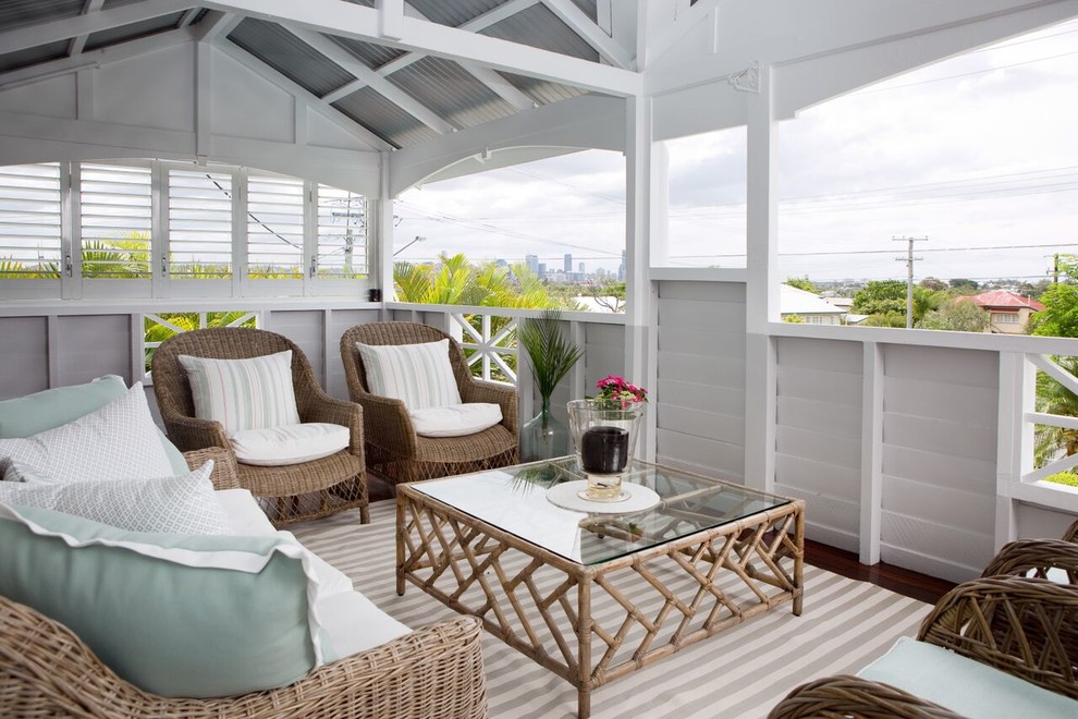 Design ideas for a beach style balcony in Brisbane with a roof extension.