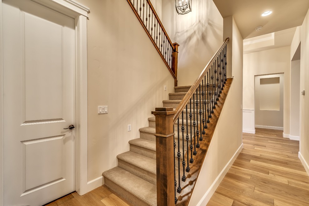 This is an example of a mid-sized transitional carpeted l-shaped staircase in Boise with carpet risers.