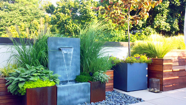 This is an example of a contemporary rooftop deck in New York with a water feature.