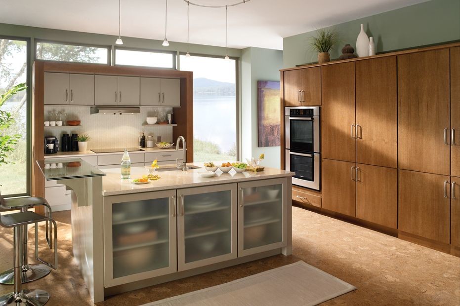Design ideas for a mid-sized modern galley separate kitchen in New Orleans with an undermount sink, flat-panel cabinets, medium wood cabinets, laminate benchtops, white splashback, ceramic splashback, stainless steel appliances, cork floors and with island.