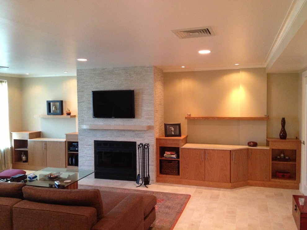 This is an example of a large contemporary formal open concept living room in Boston with beige walls, ceramic floors, a standard fireplace, a stone fireplace surround and a wall-mounted tv.