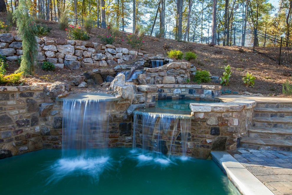 This is an example of a mid-sized arts and crafts backyard formal garden in Atlanta with with pond and brick pavers.