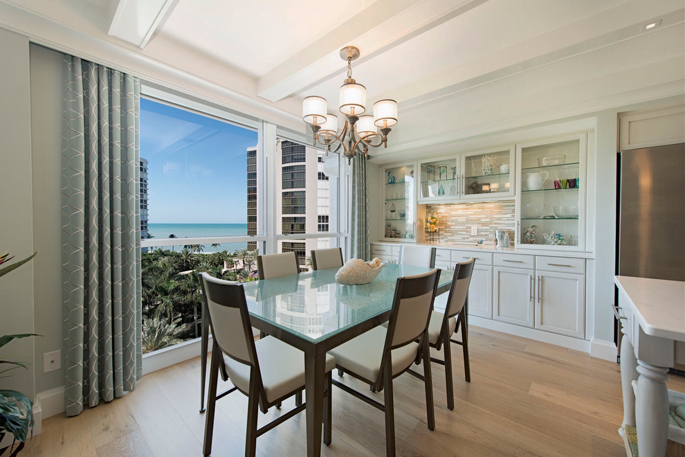 Example of a huge beach style light wood floor and beige floor kitchen/dining room combo design in Tampa with blue walls and no fireplace