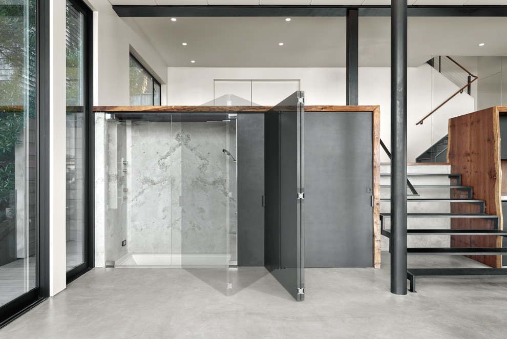 Small modern 3/4 bathroom in San Francisco with an undermount tub, gray tile, marble, grey walls, concrete floors, grey floor and an open shower.