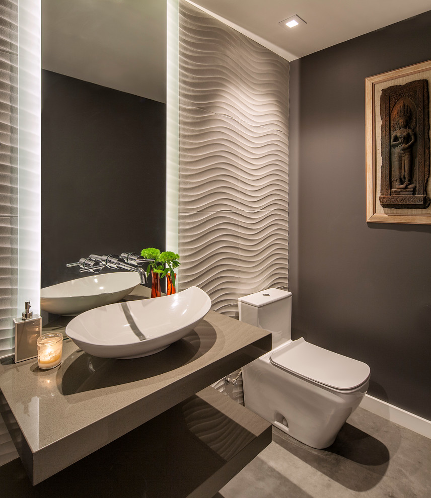 Contemporary powder room in Santa Barbara with open cabinets, a one-piece toilet, grey walls, concrete floors, a vessel sink, solid surface benchtops, grey floor and grey benchtops.