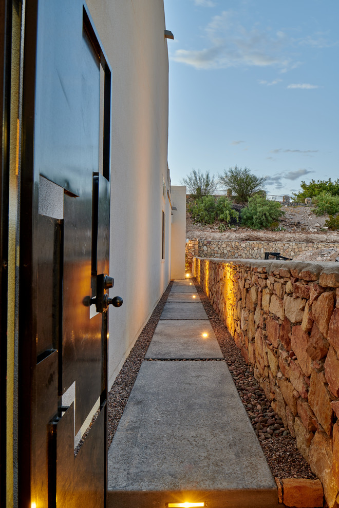 Photo of a small transitional drought-tolerant and full sun backyard gravel retaining wall landscape.