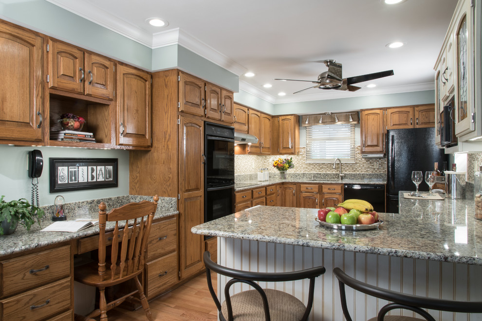 Inspiration for a transitional u-shaped medium tone wood floor kitchen pantry remodel in St Louis with a drop-in sink, multicolored backsplash, glass tile backsplash, recessed-panel cabinets, dark wood cabinets and granite countertops