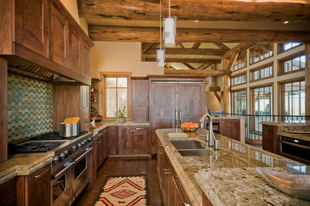 This is an example of a country galley kitchen in Denver with granite benchtops, a double-bowl sink, shaker cabinets, medium wood cabinets, cement tile splashback, stainless steel appliances, dark hardwood floors and with island.