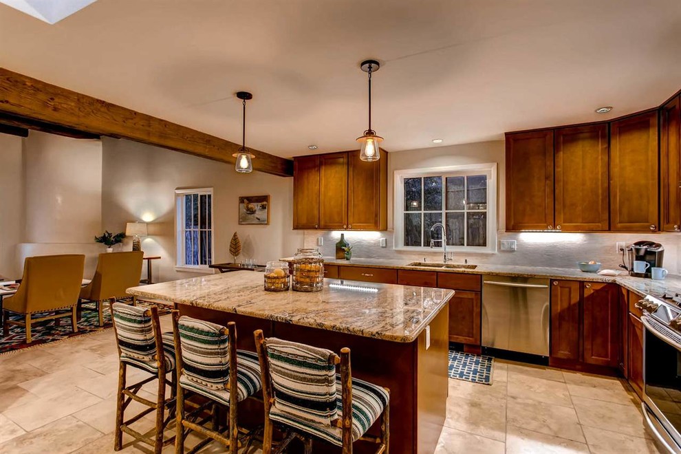 Mid-sized u-shaped eat-in kitchen in Albuquerque with a double-bowl sink, shaker cabinets, medium wood cabinets, granite benchtops, white splashback, ceramic splashback, stainless steel appliances, ceramic floors and with island.