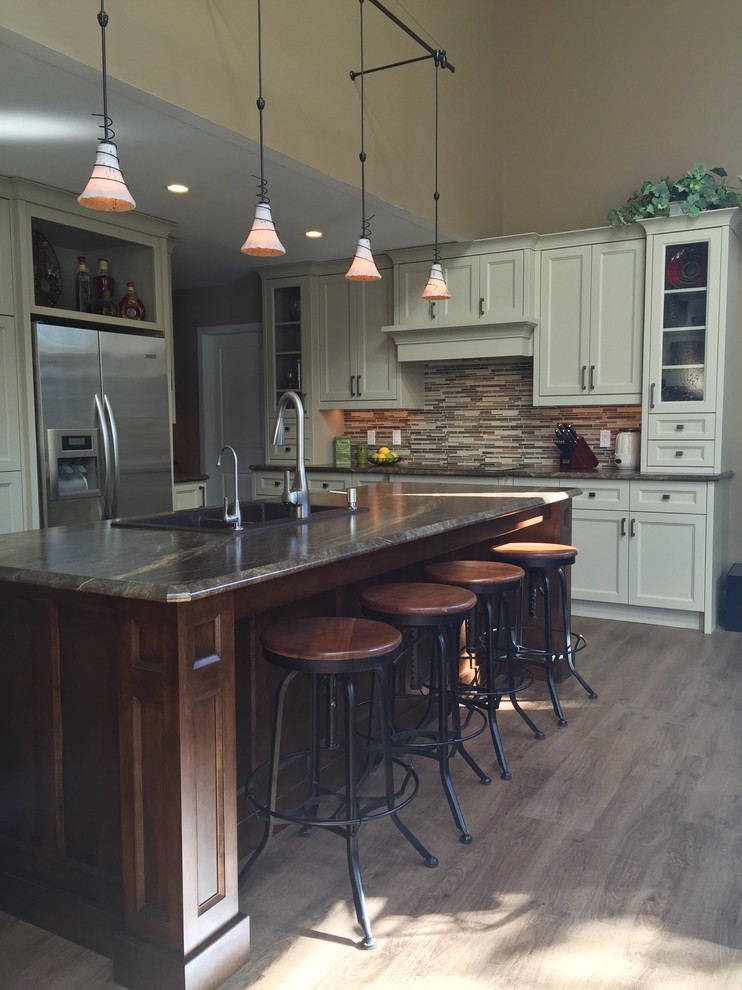 Mid-sized transitional l-shaped light wood floor and gray floor eat-in kitchen photo with a double-bowl sink, shaker cabinets, white cabinets, multicolored backsplash, matchstick tile backsplash, stainless steel appliances and an island