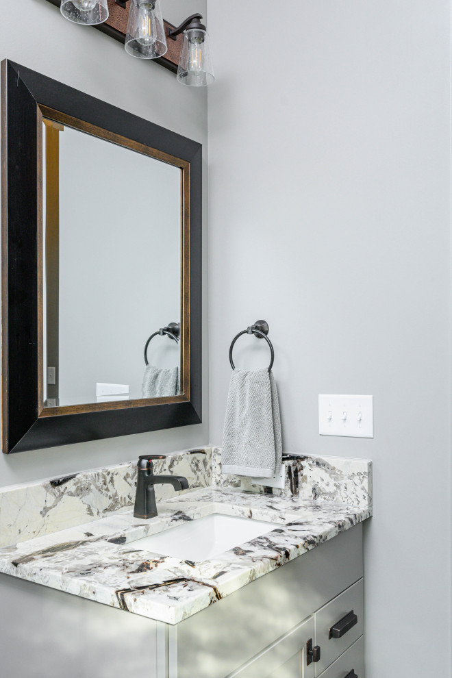 Transitional 3/4 bathroom photo with gray cabinets, gray walls, an undermount sink and multicolored countertops