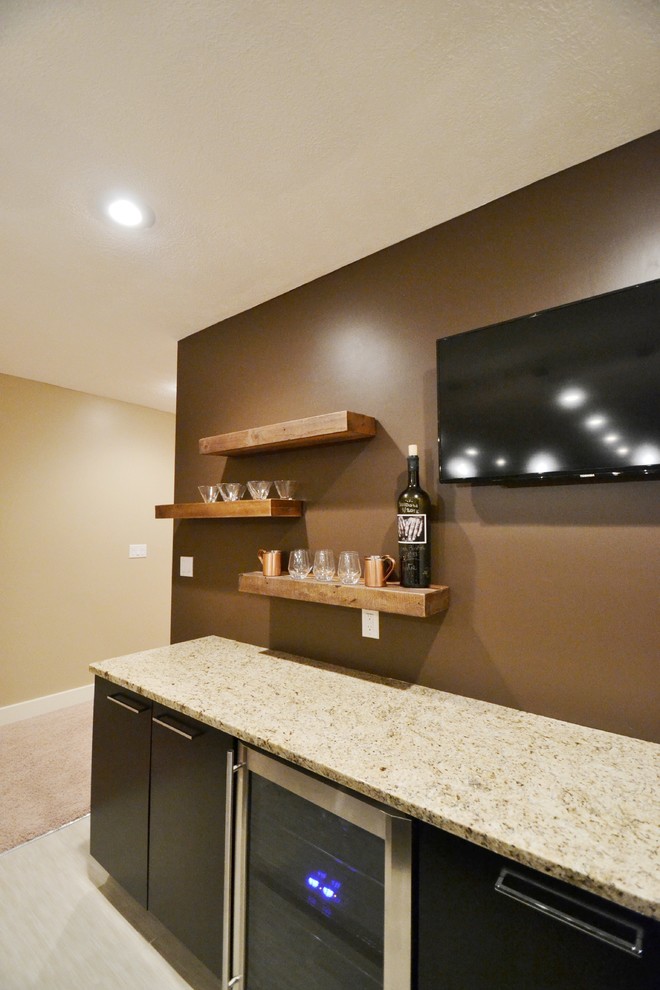 This is an example of a mid-sized traditional galley wet bar in Indianapolis with dark wood cabinets.