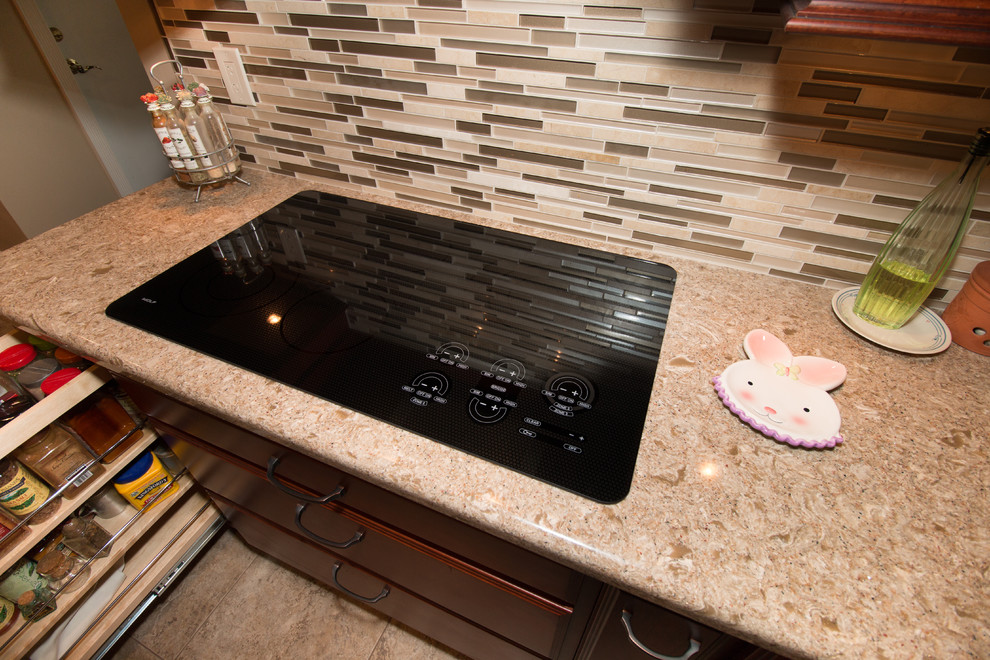 Kitchen - large transitional u-shaped porcelain tile kitchen idea with an undermount sink, flat-panel cabinets, medium tone wood cabinets, quartz countertops, beige backsplash, mosaic tile backsplash, stainless steel appliances and an island