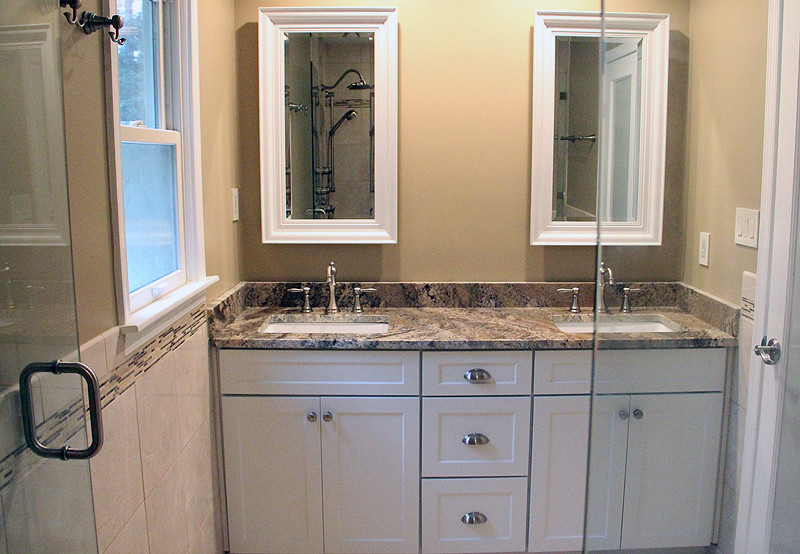 Photo of a mid-sized modern bathroom in Richmond with recessed-panel cabinets, white cabinets, multi-coloured tile, glass tile, beige walls, ceramic floors, an undermount sink, white floor and a hinged shower door.