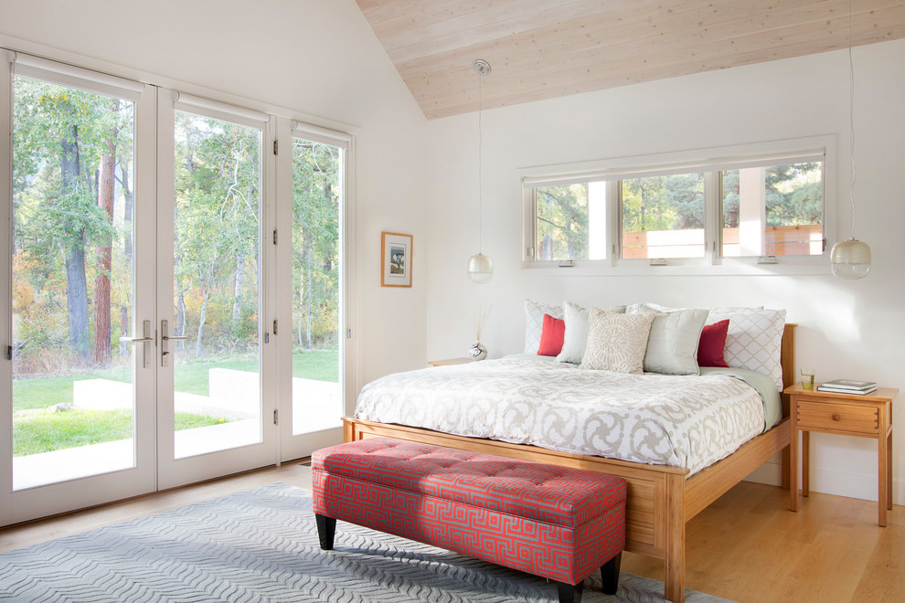 Design ideas for a mid-sized country master bedroom in Other with white walls and light hardwood floors.