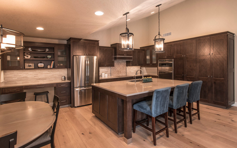 Eat-in kitchen - large transitional l-shaped light wood floor eat-in kitchen idea in Phoenix with an undermount sink, shaker cabinets, dark wood cabinets, quartz countertops, beige backsplash, matchstick tile backsplash, stainless steel appliances and an island