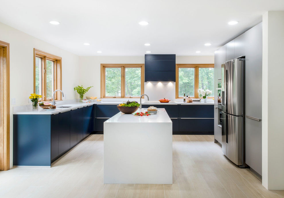 This is an example of a mid-sized modern l-shaped eat-in kitchen in Boston with an undermount sink, flat-panel cabinets, grey cabinets, quartz benchtops, stainless steel appliances, porcelain floors, with island, beige floor and white benchtop.