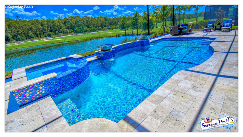 Large traditional backyard rectangular lap pool in Tampa with a pool house and natural stone pavers.