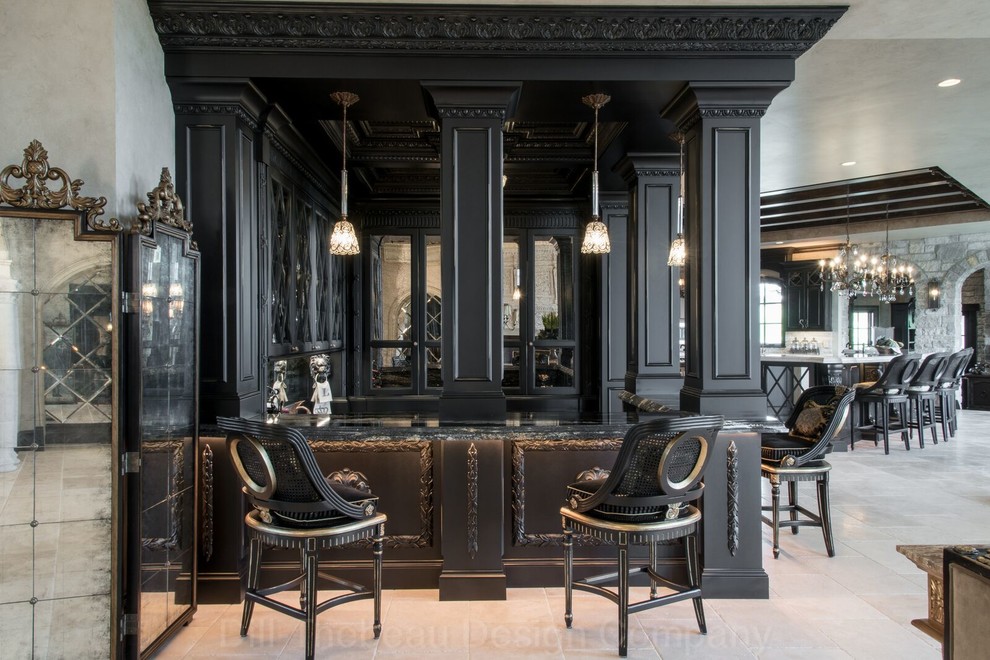 This is an example of a mid-sized traditional u-shaped home bar in St Louis with black cabinets.