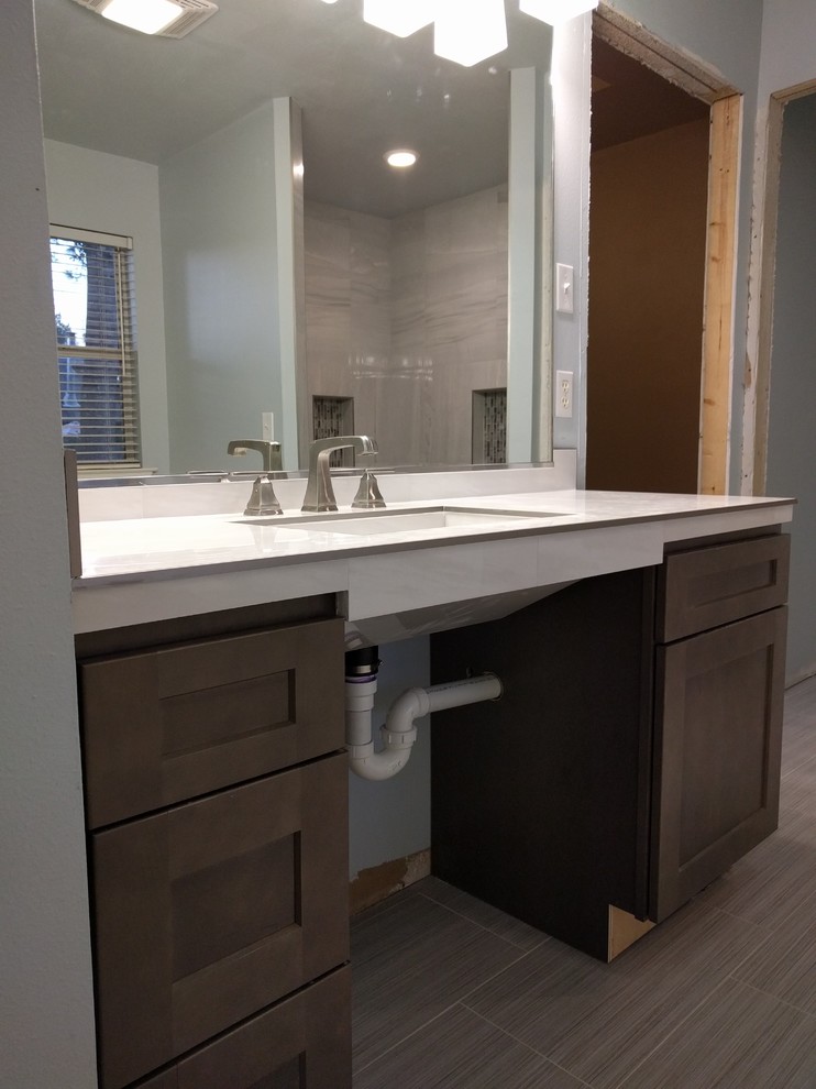 Inspiration for a mid-sized contemporary master bathroom in New Orleans with shaker cabinets, dark wood cabinets, a curbless shower, white tile, porcelain tile, blue walls, porcelain floors, a trough sink and tile benchtops.