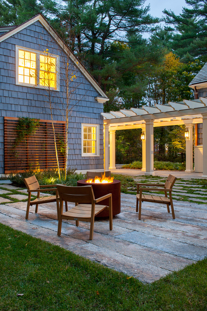 Photo of a traditional patio in Boston with a fire feature.