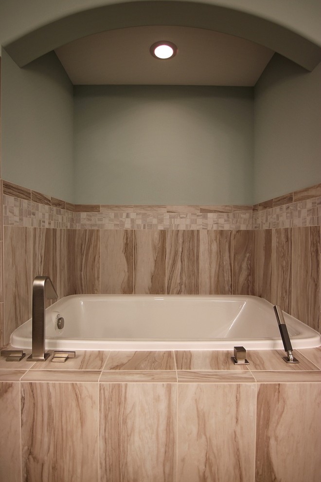 Example of a mid-sized transitional 3/4 multicolored tile and matchstick tile drop-in bathtub design in Chicago with flat-panel cabinets, dark wood cabinets, beige walls, an undermount sink and granite countertops