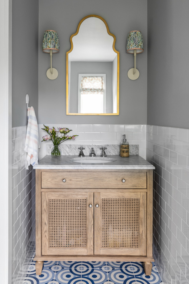 Inspiration for a mid-sized scandinavian kids bathroom in DC Metro with shaker cabinets, medium wood cabinets, a one-piece toilet, gray tile, ceramic tile, white walls, cement tiles, an undermount sink, marble benchtops, multi-coloured floor, white benchtops, a single vanity and a freestanding vanity.