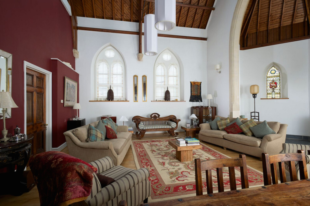 This is an example of a large traditional open concept living room in Dorset with light hardwood floors.