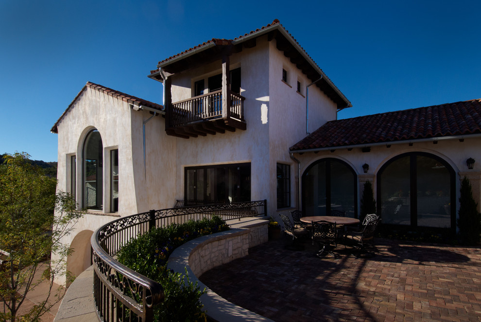 This is an example of a large mediterranean two-storey stucco white exterior in Denver.