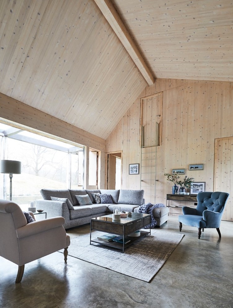 This is an example of an expansive scandinavian open concept living room in Other with grey floor.