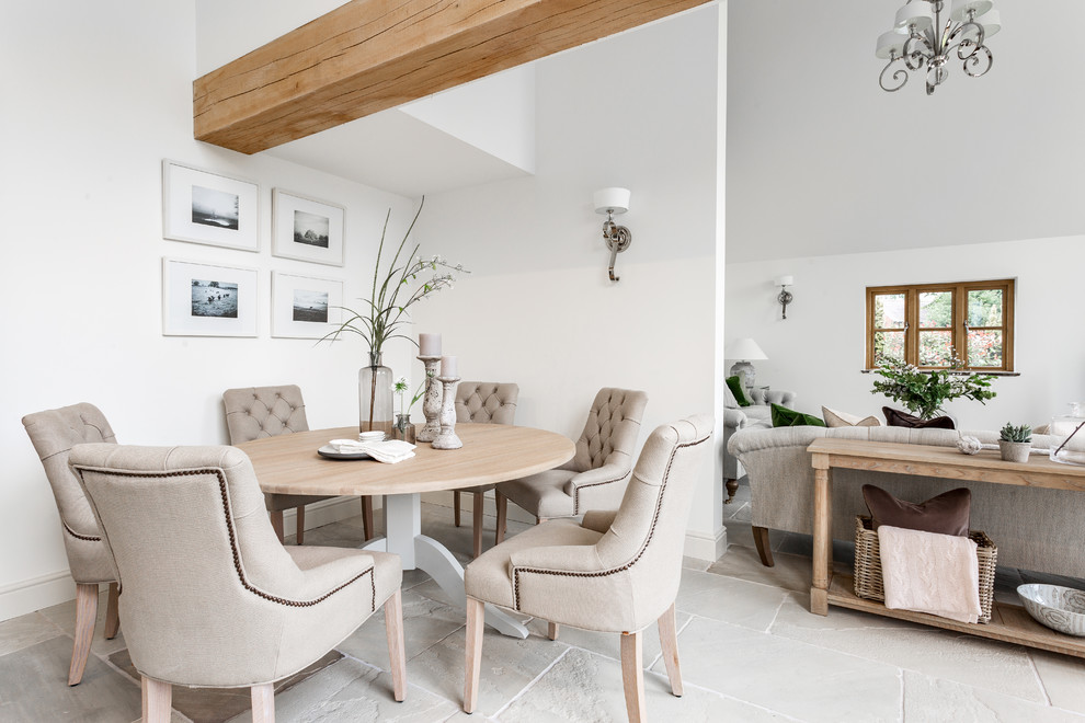 Mid-sized country open plan dining in Other with limestone floors, white walls and grey floor.