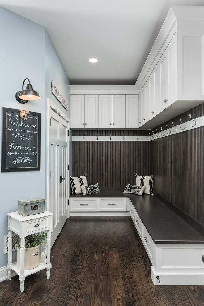 Elegant dark wood floor and brown floor mudroom photo in Chicago with blue walls