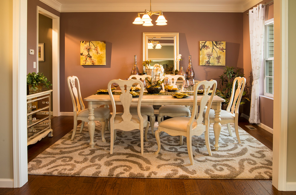 Mid-sized traditional separate dining room in Other with pink walls, dark hardwood floors and no fireplace.