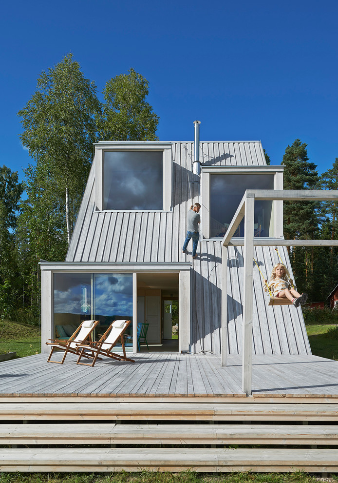 This is an example of a mid-sized scandinavian backyard deck in Stockholm.