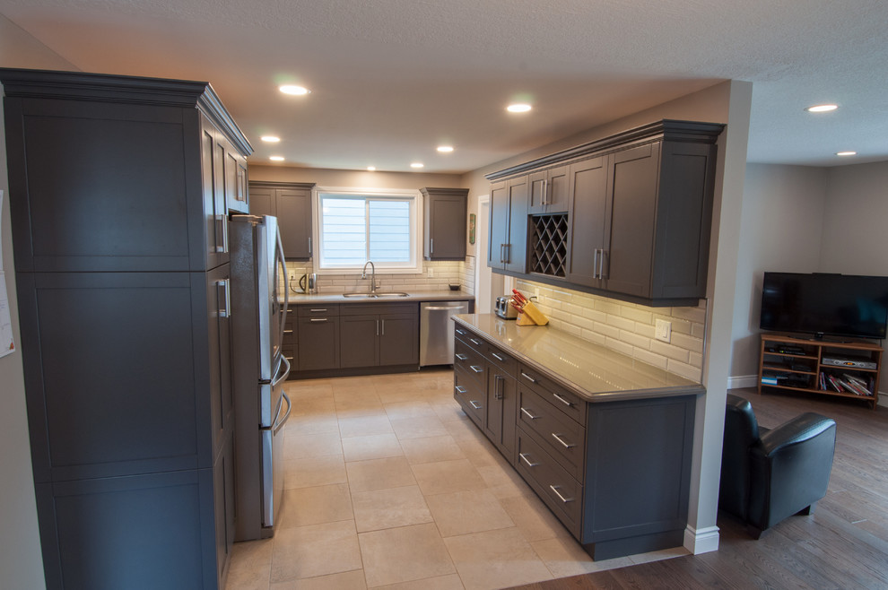 Example of a mid-sized transitional u-shaped ceramic tile and beige floor enclosed kitchen design in Toronto with a double-bowl sink, shaker cabinets, dark wood cabinets, quartzite countertops, beige backsplash, subway tile backsplash, stainless steel appliances and no island