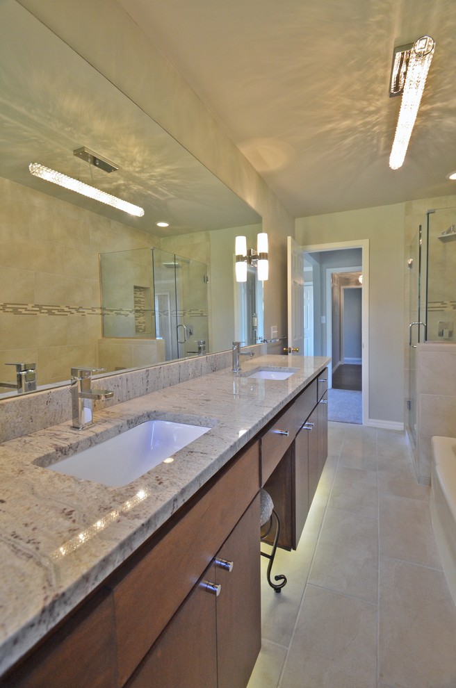 Photo of a mid-sized traditional master bathroom in Oklahoma City with flat-panel cabinets, medium wood cabinets, a corner tub, a corner shower, a one-piece toilet, brown walls, ceramic floors, an undermount sink and quartzite benchtops.