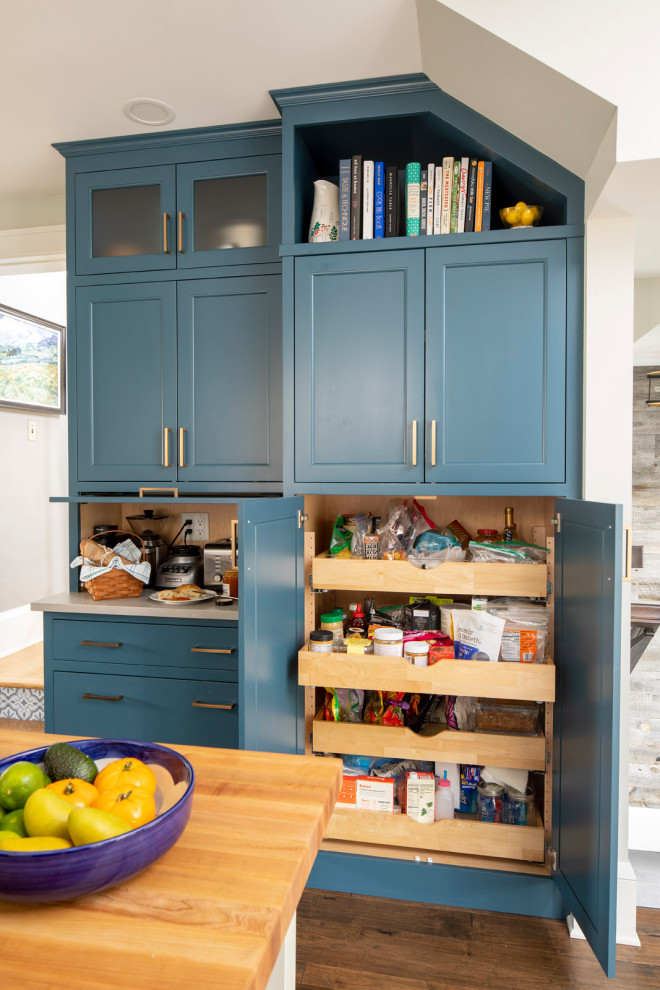Example of a mid-sized cottage galley vinyl floor and brown floor kitchen pantry design in Minneapolis with blue cabinets, ceramic backsplash and white countertops