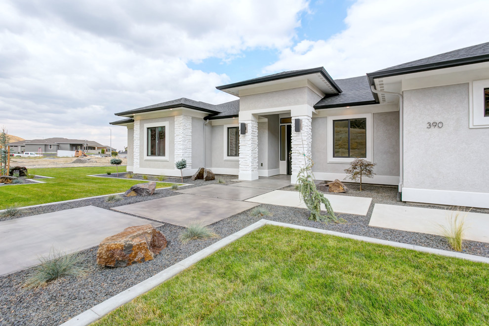 Mid-sized transitional gray one-story stucco house exterior photo in Seattle with a hip roof and a shingle roof